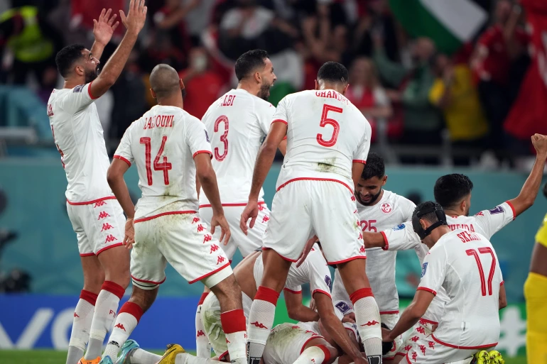Wahbi Khazri and teammates celebrate scoring against France in the World Cup at Education City Stadium [Sorin Furcoi/Al Jazeera]