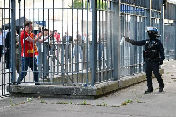 Riot police sprayed Liverpool fans outside the stadium. (Photo: Getty Images)