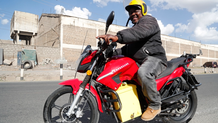 A man rides an electric motorcycle from Ampersand on a test drive in Nairobi, Kenya, Jan. 23, 2023. Electric motorcycles are gaining traction in Kenya as private sector-led firms rush to set up charging points and battery-swapping stations to speed up the growth of cleaner transport and put the east African nation on a path toward fresher air and lower emissions. [Photo/Courtesy]