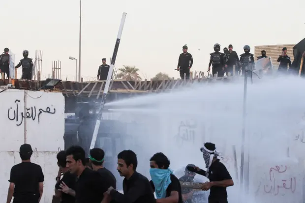 Security forces deploy a water cannon as protesters gather near the Swedish embassy in Baghdad. [Photo/Courtesy]