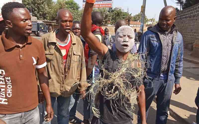 A Kisumu protester smears flour on his face as he protests against the high cost of the basic commodities. [Photo/Standard]