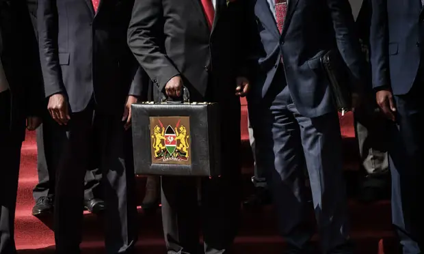Kenya’s budget briefcase en route to parliament in Nairobi. But balancing the books is proving harder than ever. [Photo/Getty Images]