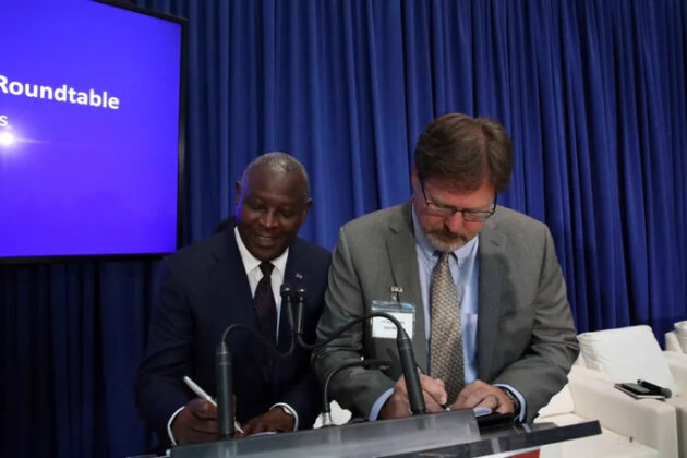 Equity Group Managing Director and CEO Dr. James Mwangi (left) and John Deere, Head of Business for Africa, Asia and the Middle East, Jason Brantley (right) sign a financing and collaboration agreement between Equity Group Holdings and John Deer/COURTESY
