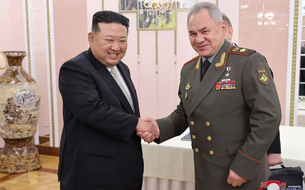 Kim Jong-un (left) and Sergei Shoigu shaking hands at the office building of the Party Central Committee in Pyongyang [Photo/AFP] Ukraine
