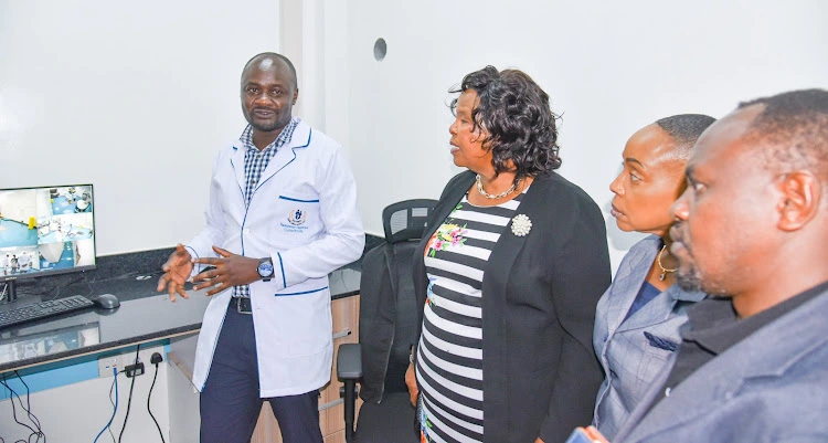 KUTRRH Physists Peter Loreh updates Board Chair Prof Olive Mugenda on Cyber Knife procedure as board members Kavi Mwendwa and Nzumbi Mulatya looks on.[Photo/Handout] Hospital