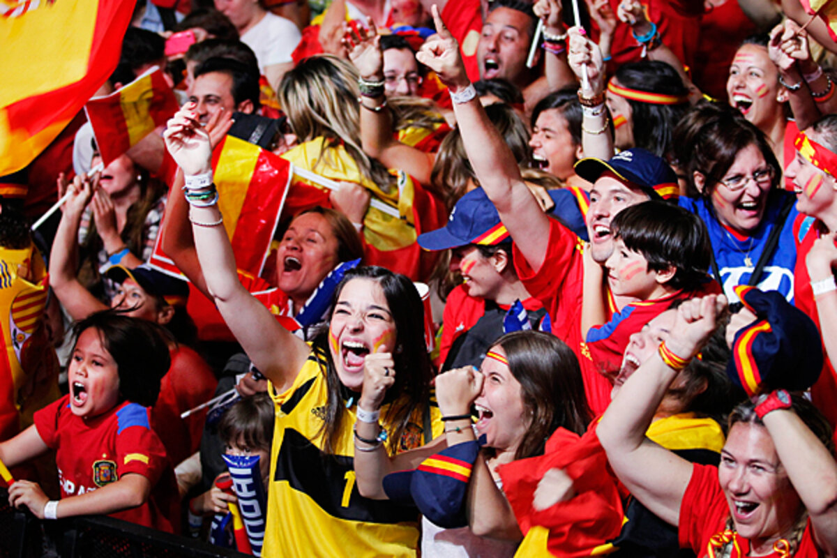 Spanish football fans celebrate Spain's World Cup victory in Madrid as crowds gather in the streets and prepare for the team's victory parade.