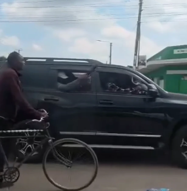 Masked men and security vehicles near AC Primary School in Ol Kalou after teargas was reportedly fired to disperse crowds, as voters gathered outside the polling station amid allegations of election interference.