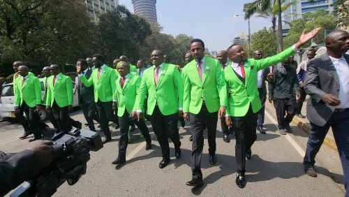 DCP Members of Parliament and senior party officials pose for a group photo outside Parliament Buildings in Nairobi during the swearing-in of Ol Kalou MP Sammy Douglas Kamau Ngotho, highlighting the party's growing representation following recent by-election victories.