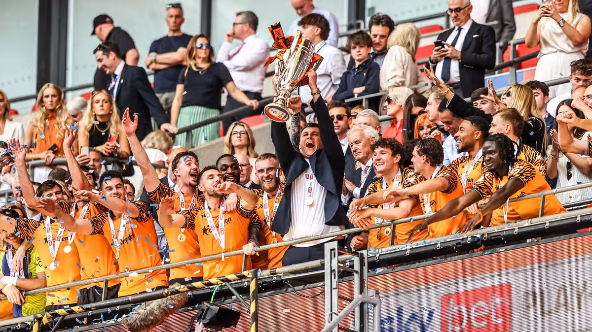 Hull City players celebrate winning the Championship play-off final after Oli McBurnie’s late goal secured Premier League promotion.